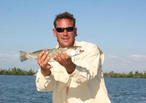 Captain Scooter Ahrens holding his big catch aboard the Tribal 14