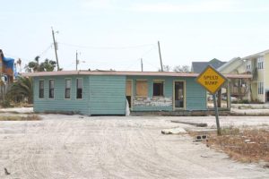 This was taken on our long walk on sand covered roads after Hurricane Ivan to retrieve whatever was not destroyed and that we could carry on our backs. Please note that house was previously on a foundation two blocks away and is ended up residing in the middle of my street.